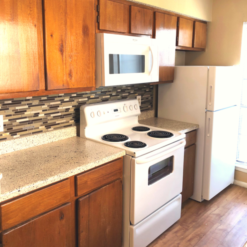 a kitchen with a stove and a microwave