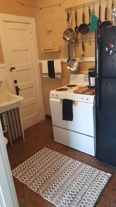 a small kitchen with a stove and a refrigerator