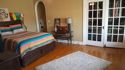 a bedroom with a bed and a door to a patio