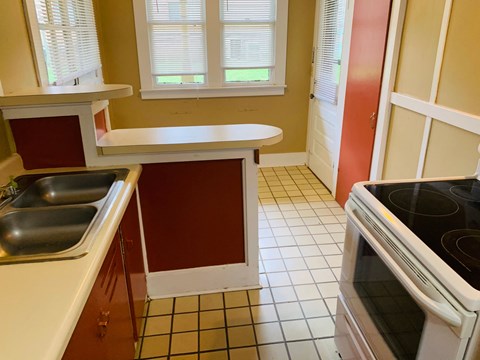 a kitchen with a stove and a sink and a counter
