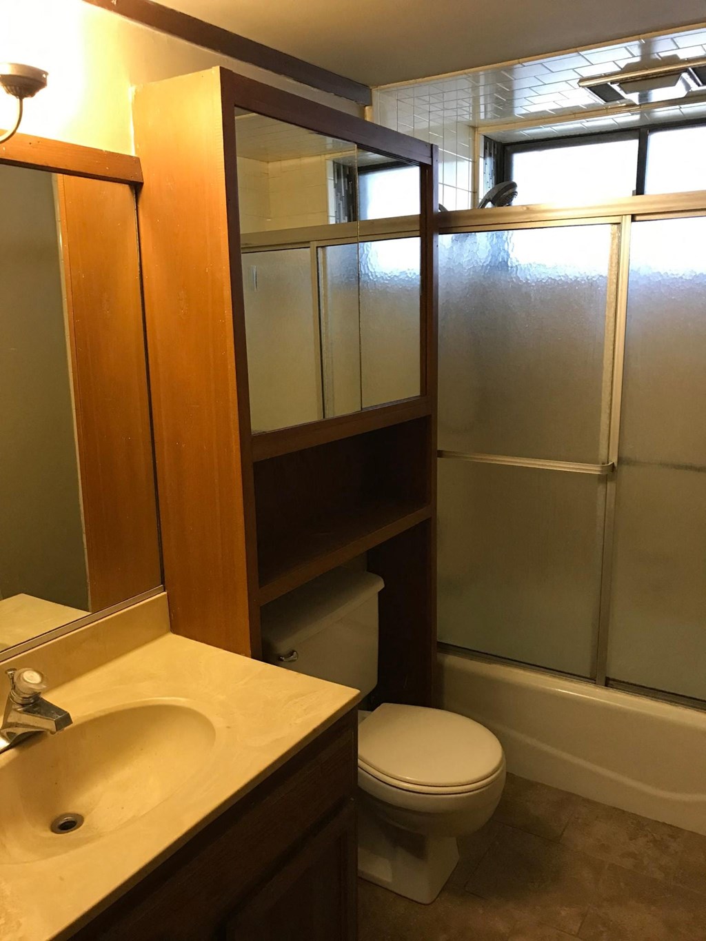 a small bathroom with a sink toilet and shower