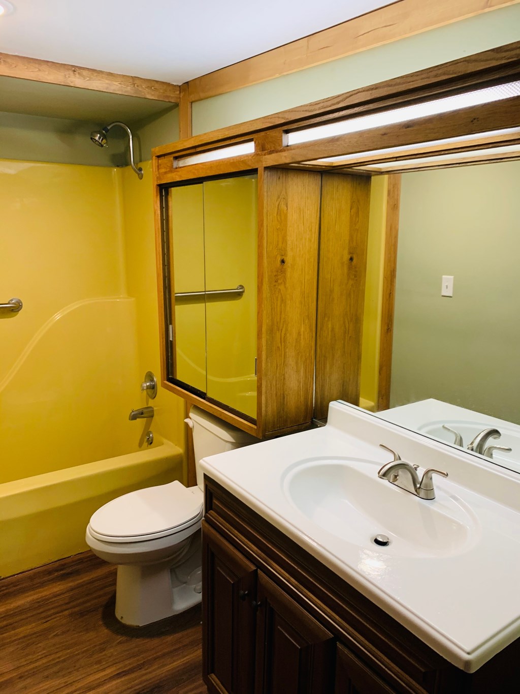 a bathroom with a sink and a toilet and a shower