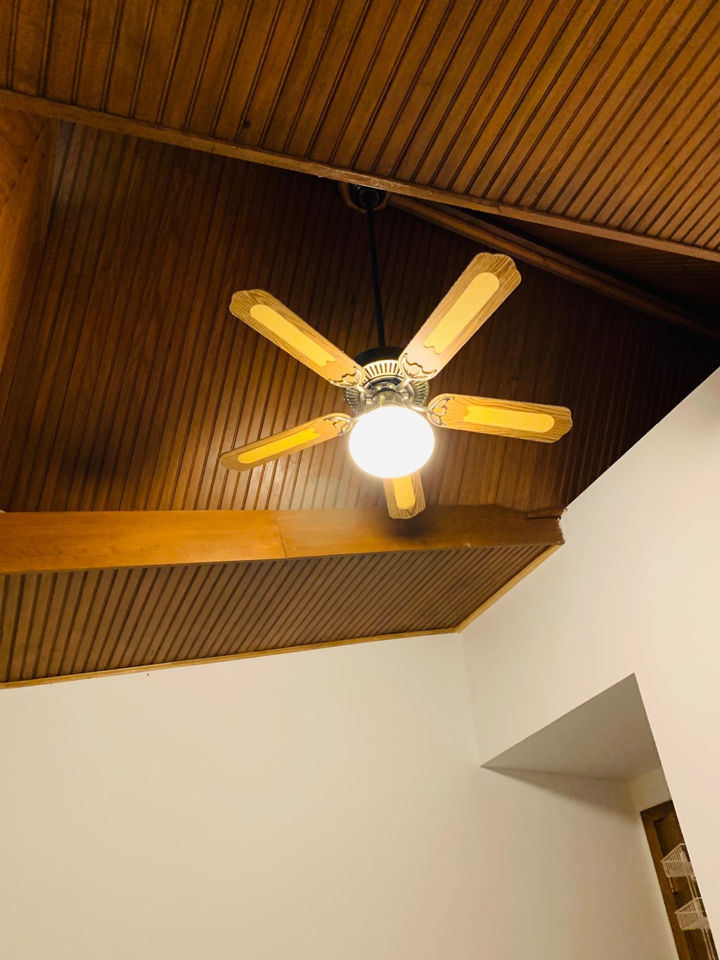 a ceiling fan hanging from a ceiling in a room