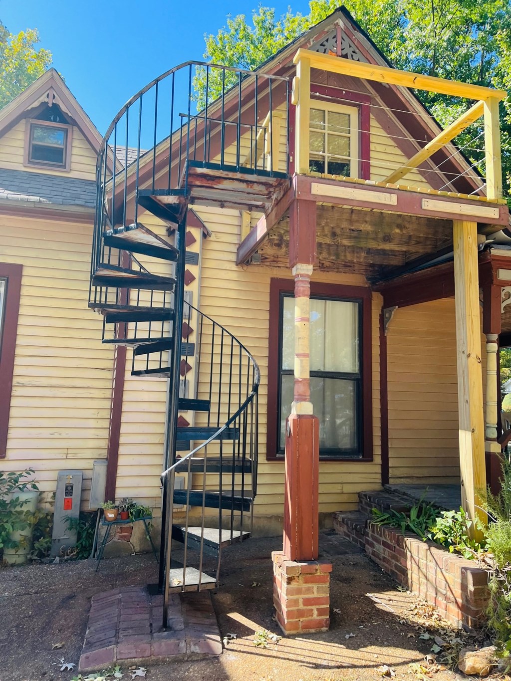 a spiral staircase on the side of a house