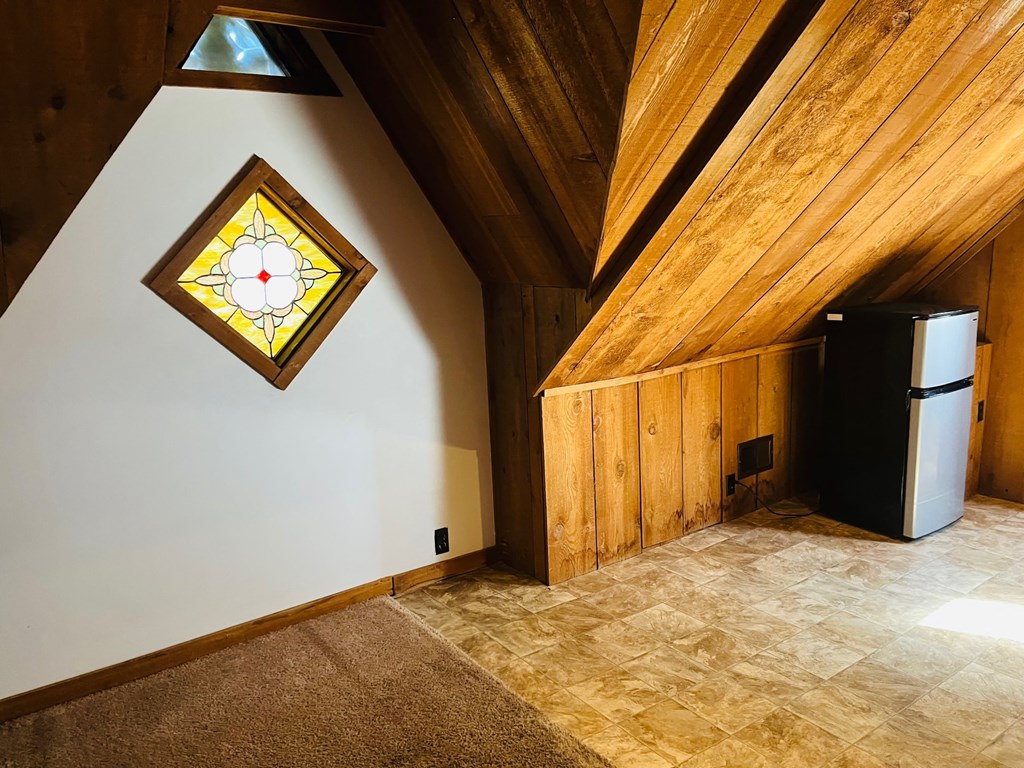 a room with a refrigerator and a stained glass window
