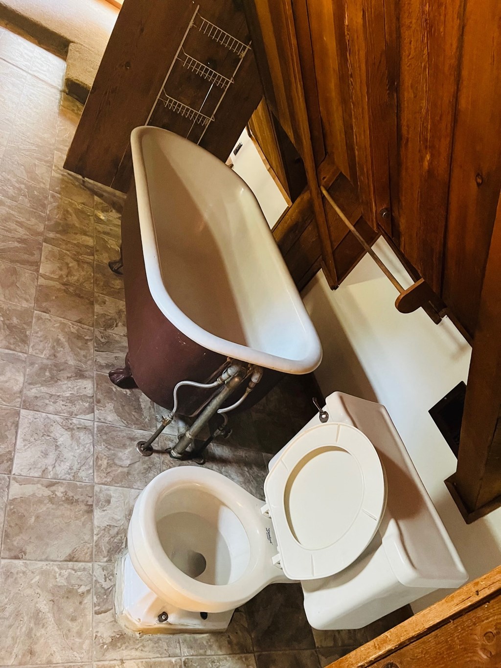 a bathroom with a toilet and a tub and a sink