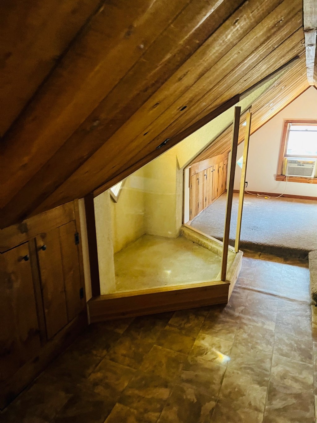 the attic of a house with a staircase and wooden beams