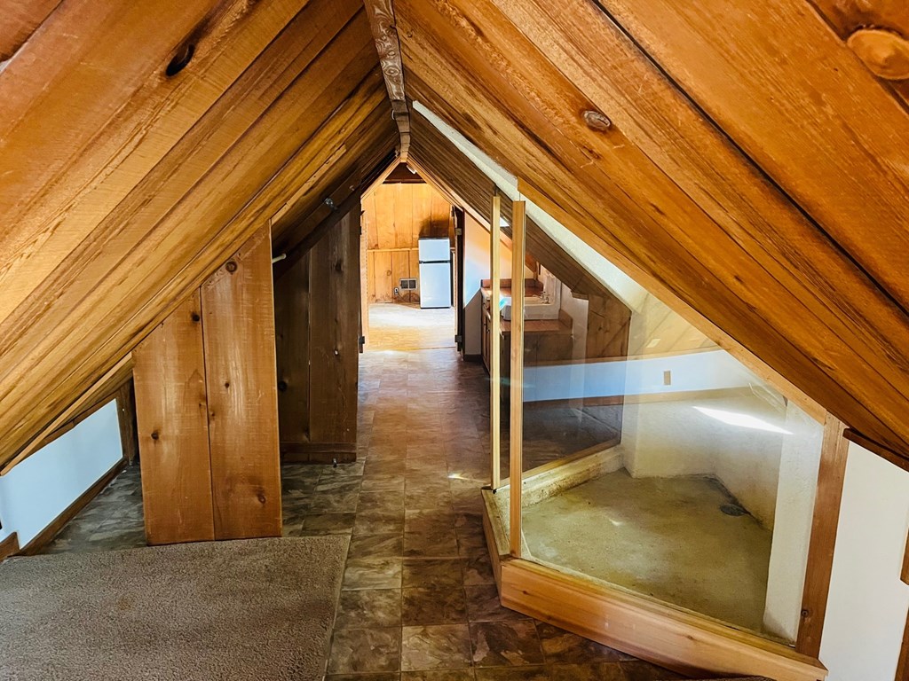 a view of the attic from the top of the stairs
