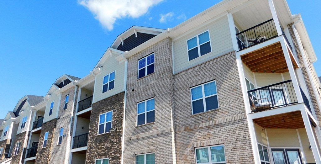 a brick apartment building with a blue sky in the background