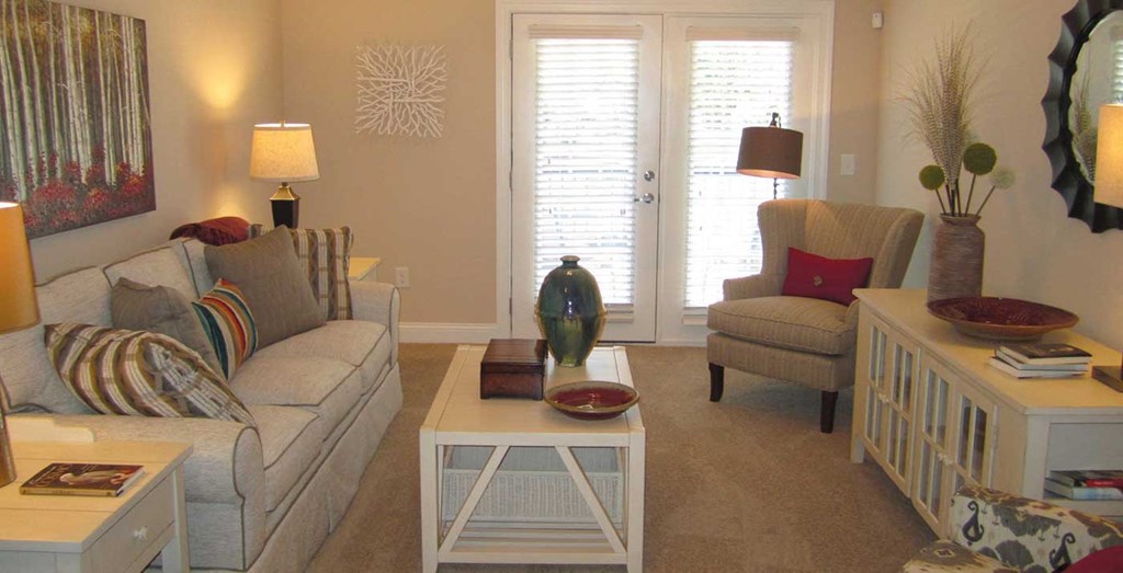 a living room with couches and chairs and a table