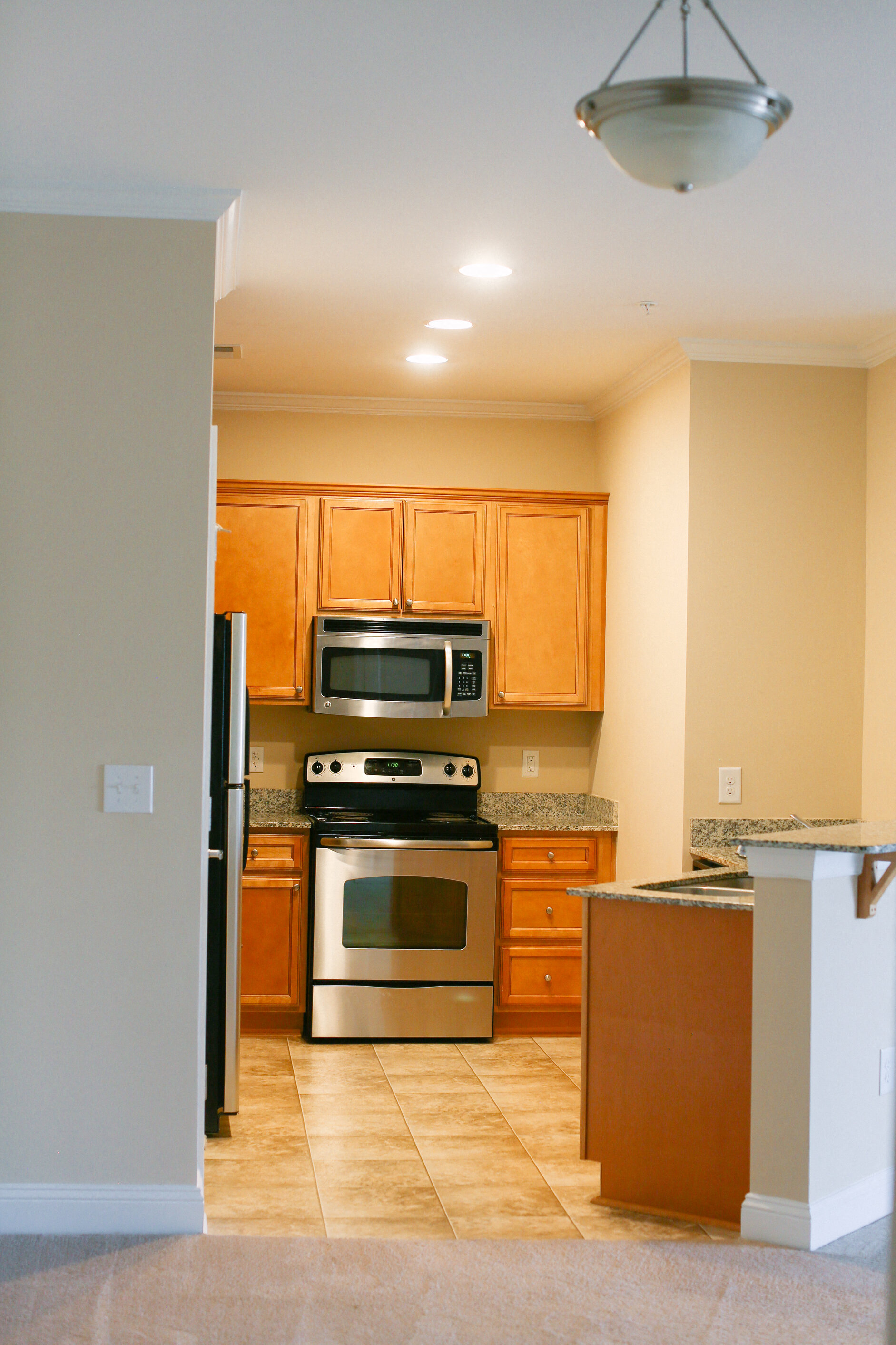 a kitchen with stainless steel appliances and wooden cabinets