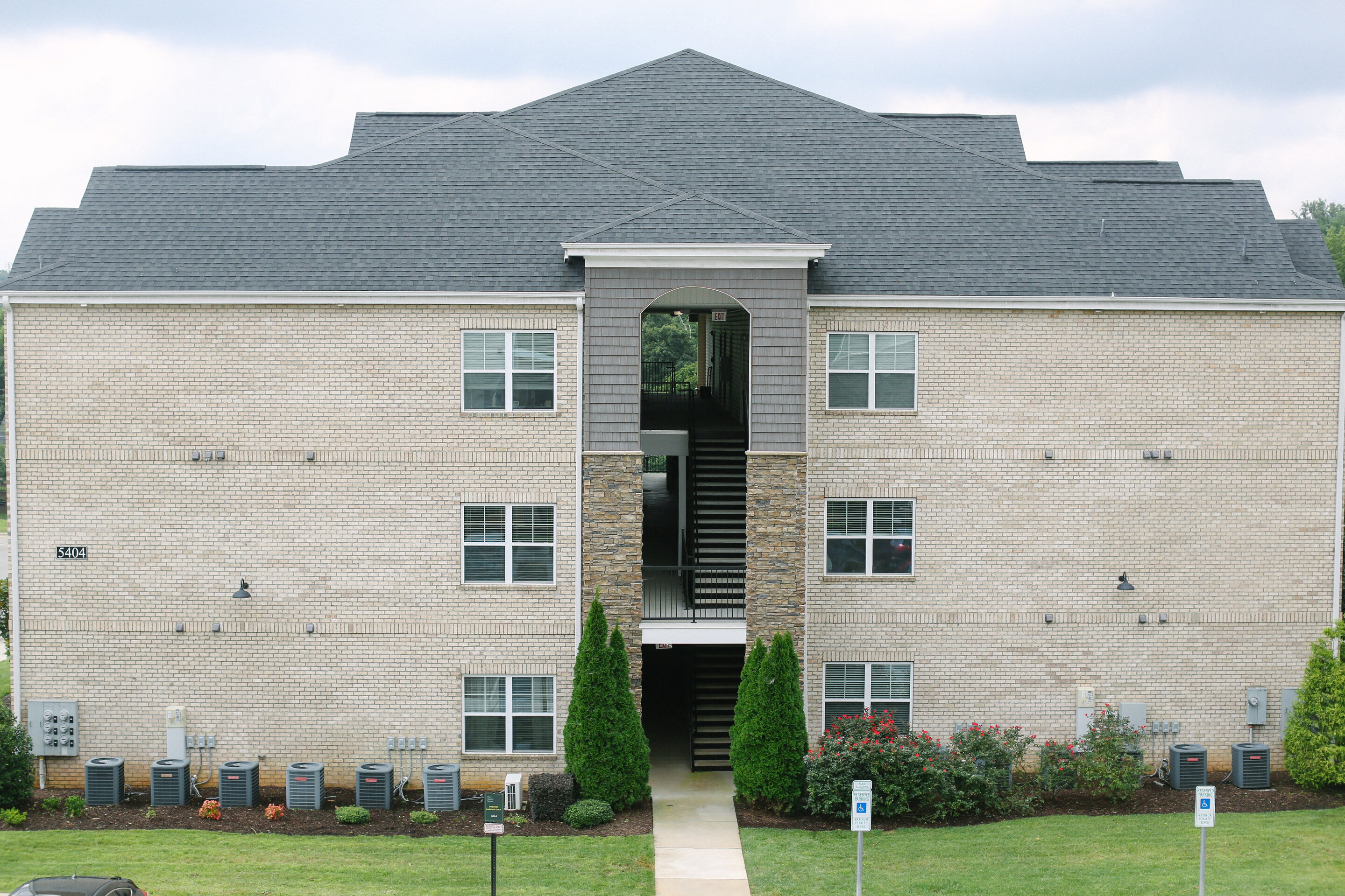the front of a brick house with an open door