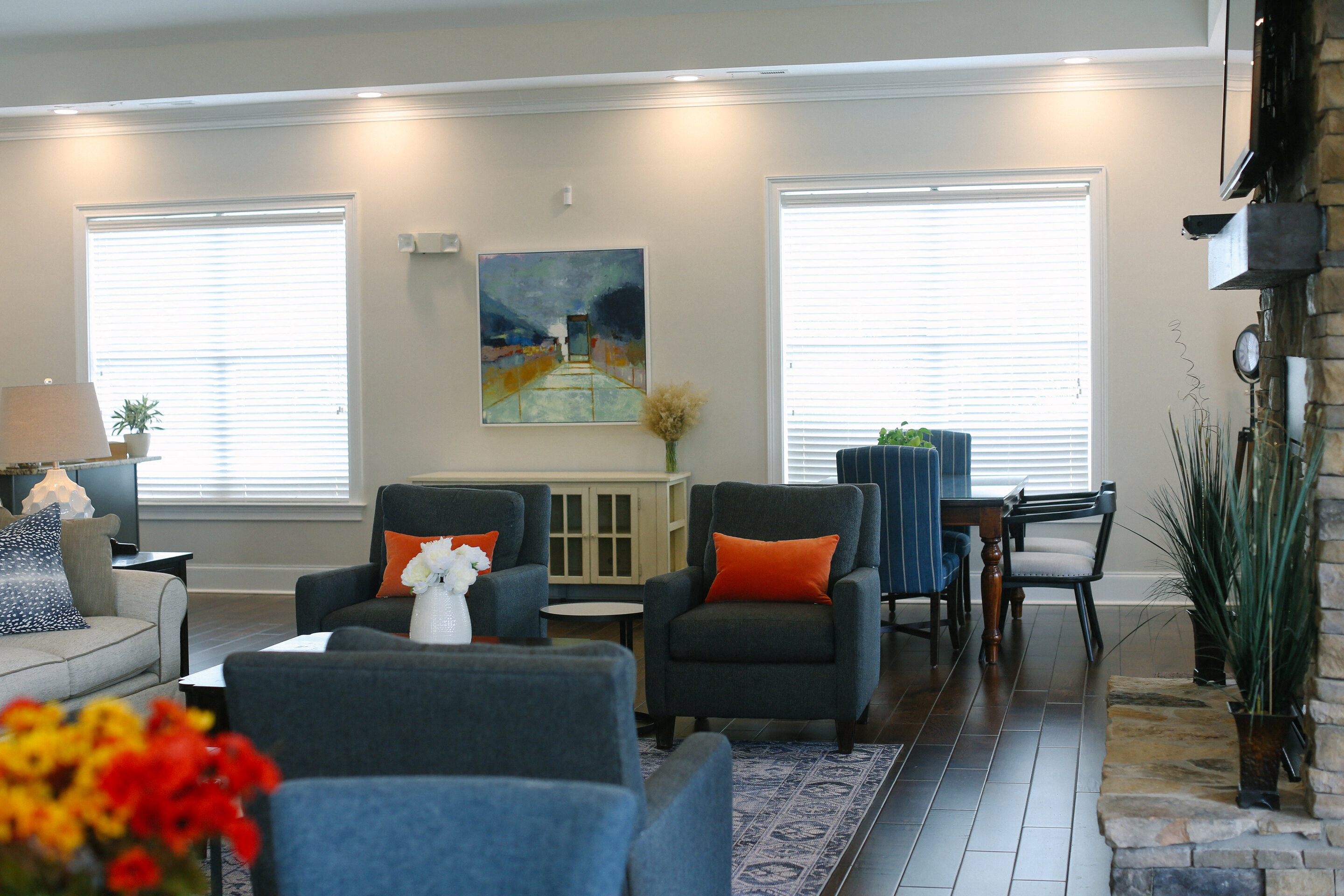 a living room and dining room with chairs and a table