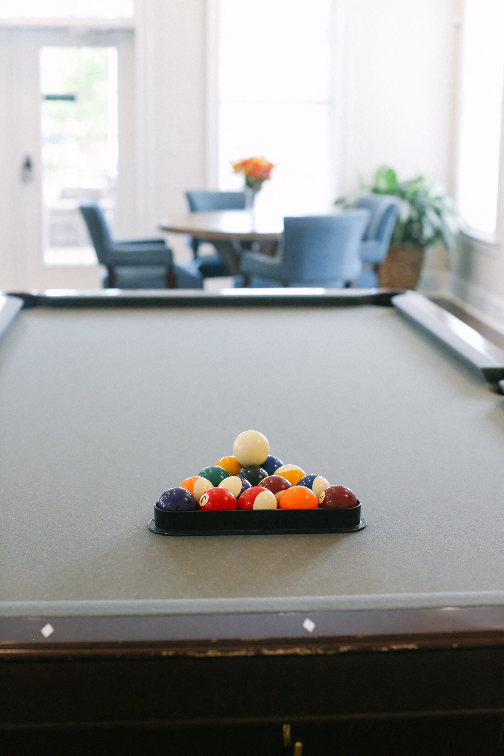 a pool table in a living room with billiard balls on it