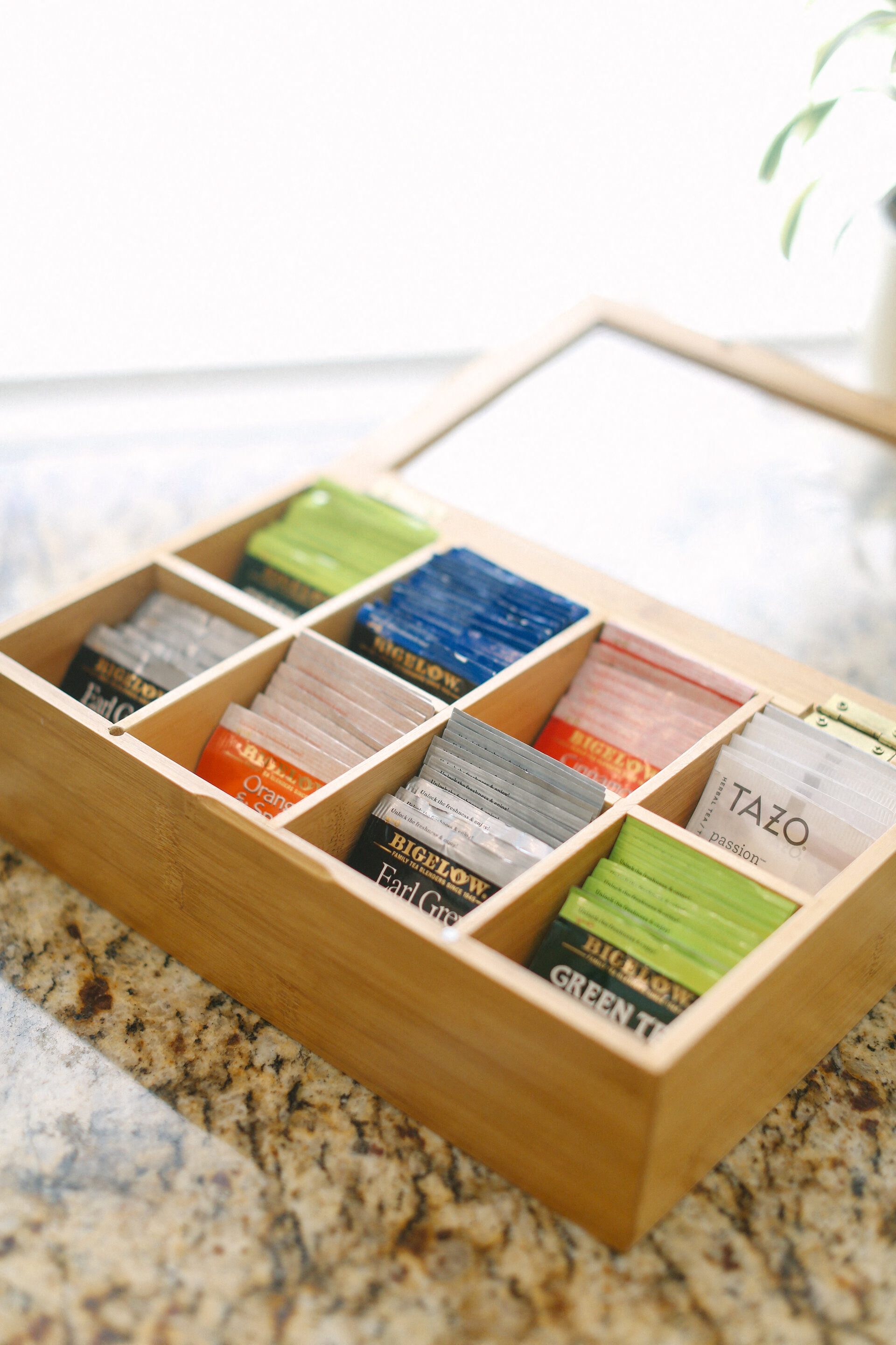 a wooden tray filled with different brands of nail polish on a table