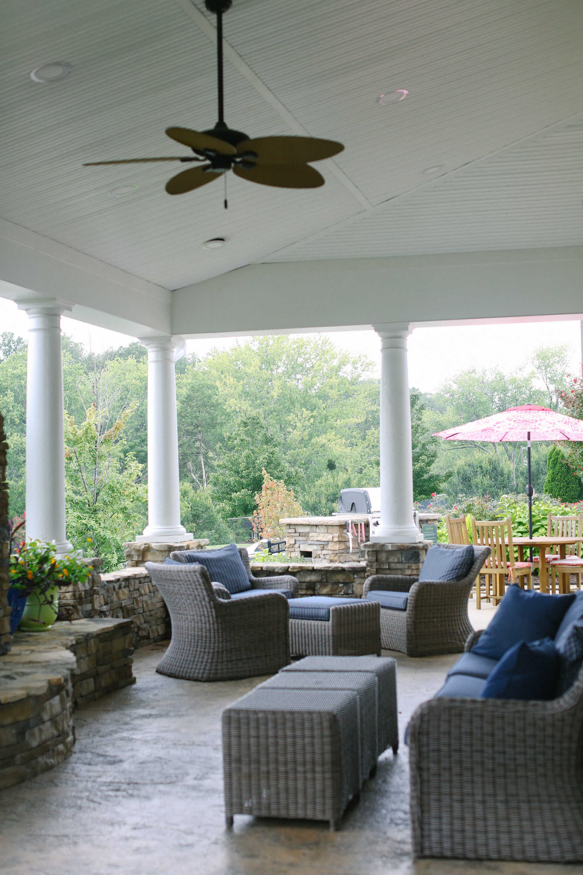 a covered patio with furniture and a ceiling fan