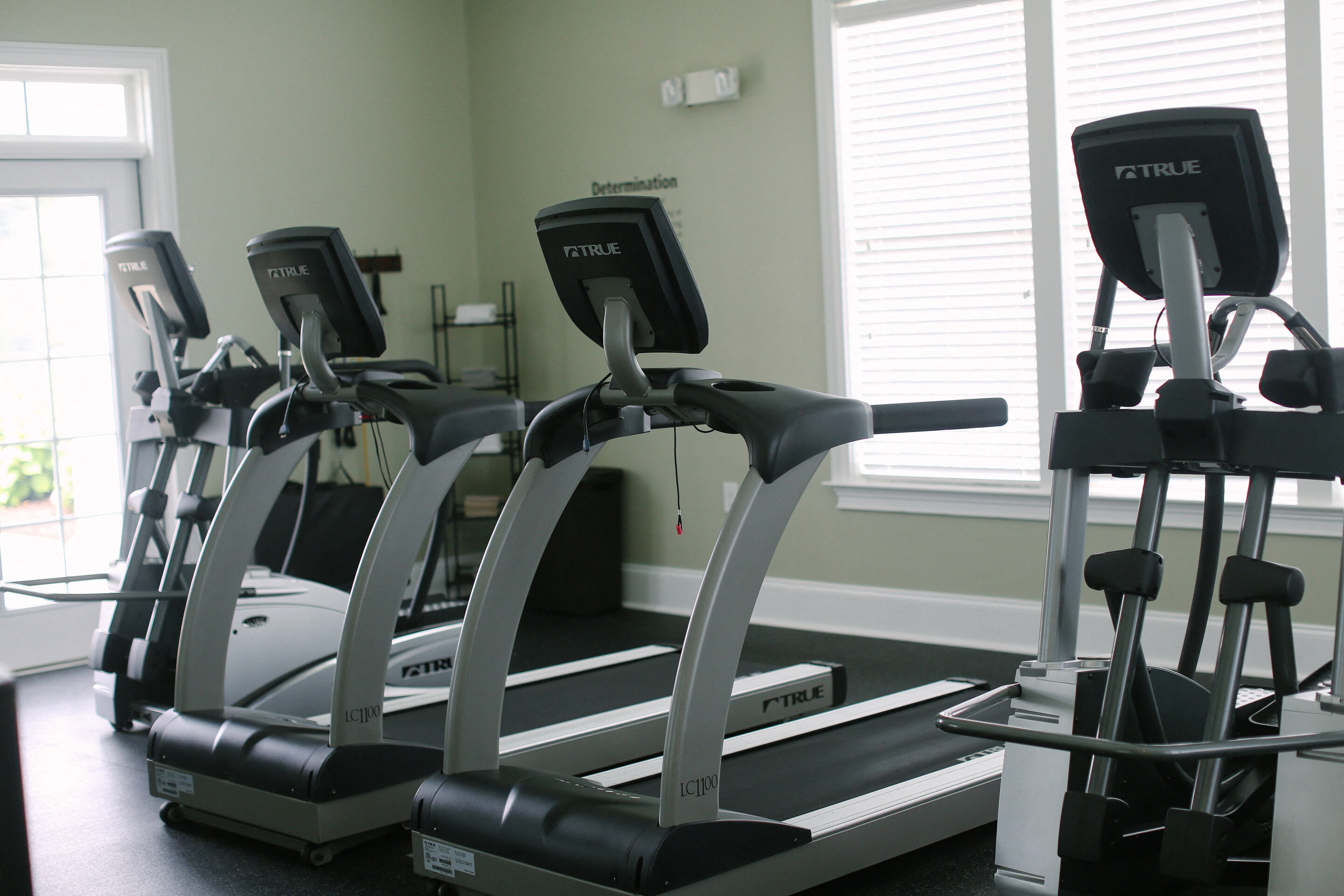 a row of exercise machines in a gym