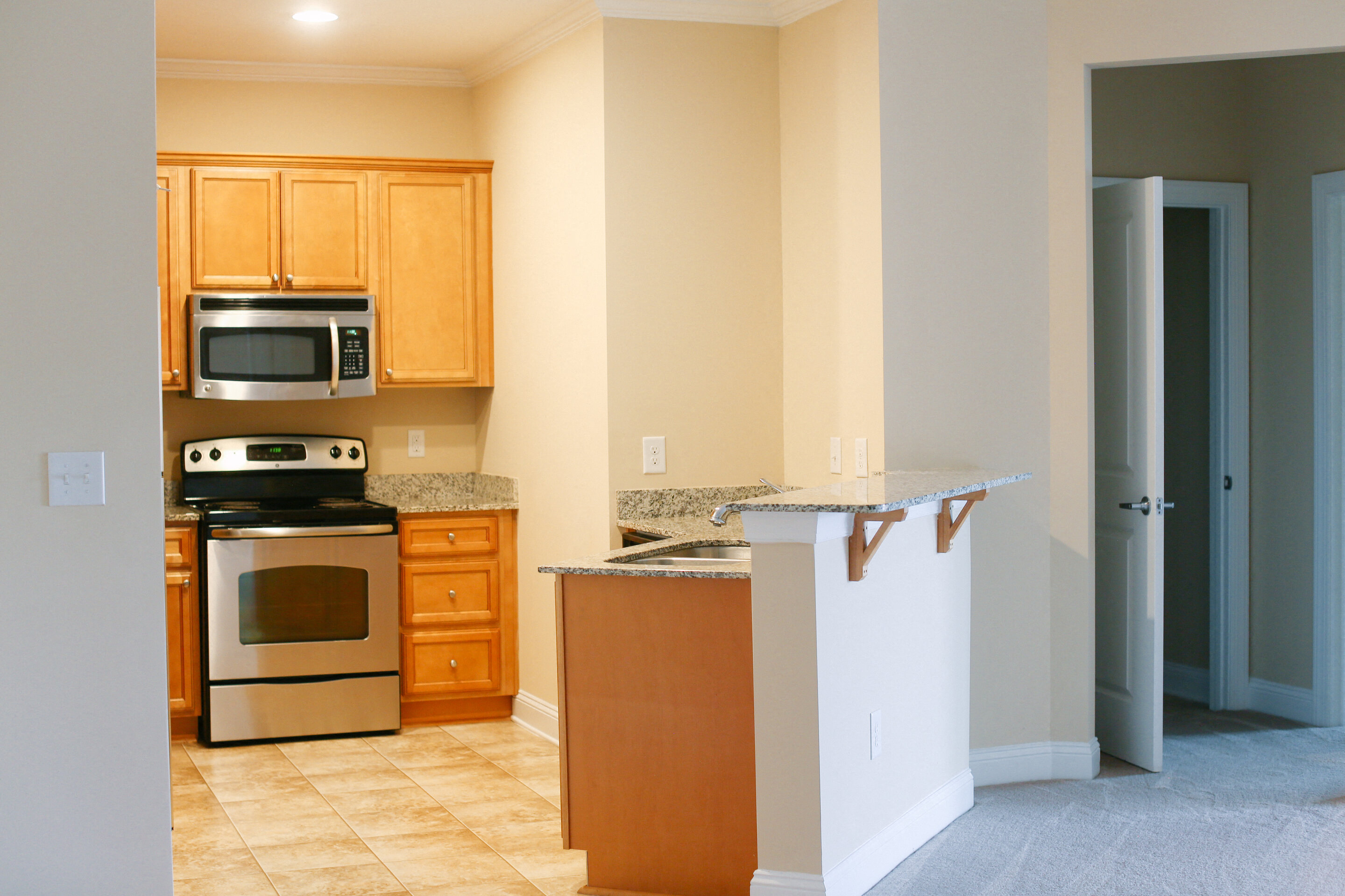 a kitchen with stainless steel appliances and wooden cabinets