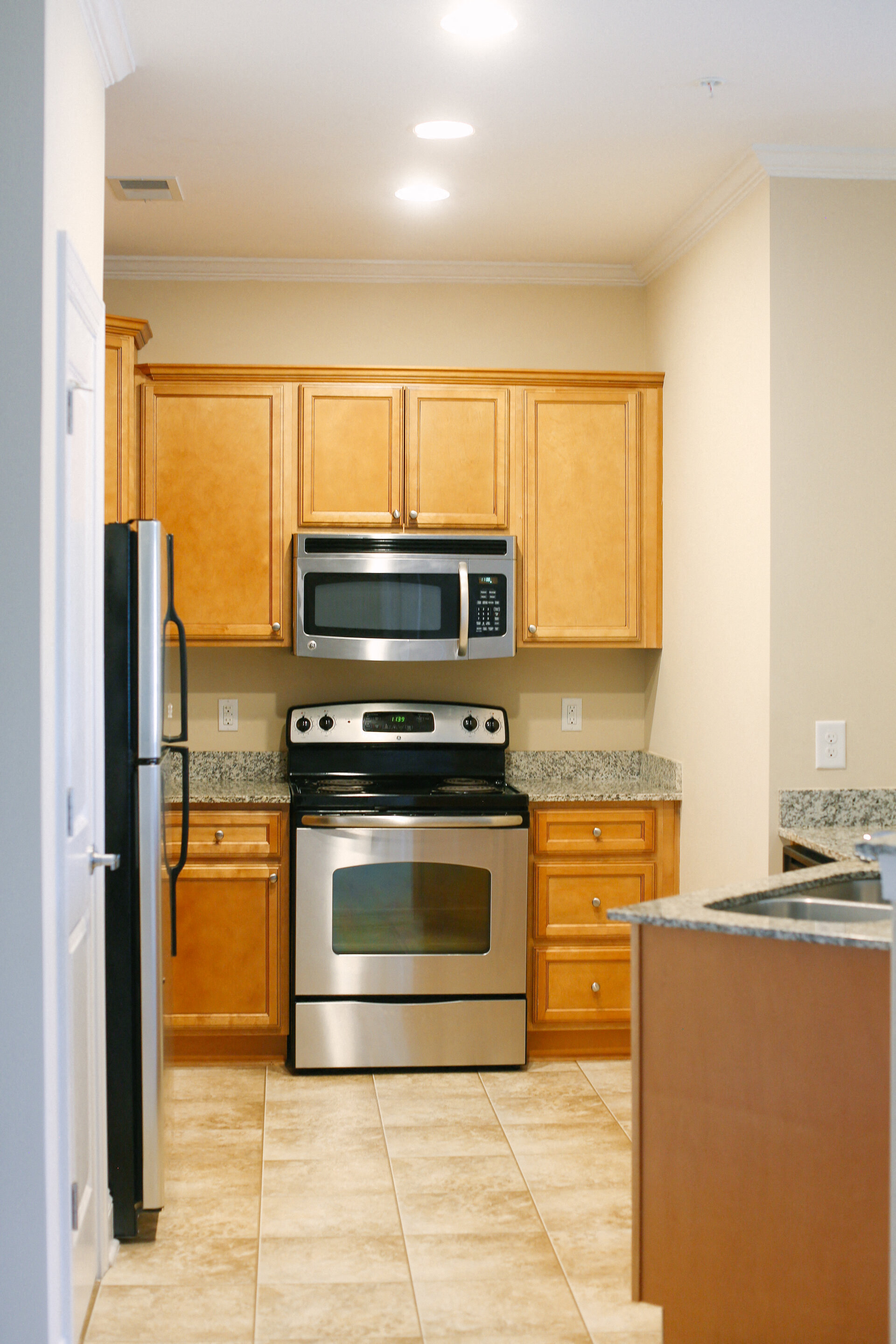 a kitchen with stainless steel appliances and wooden cabinets