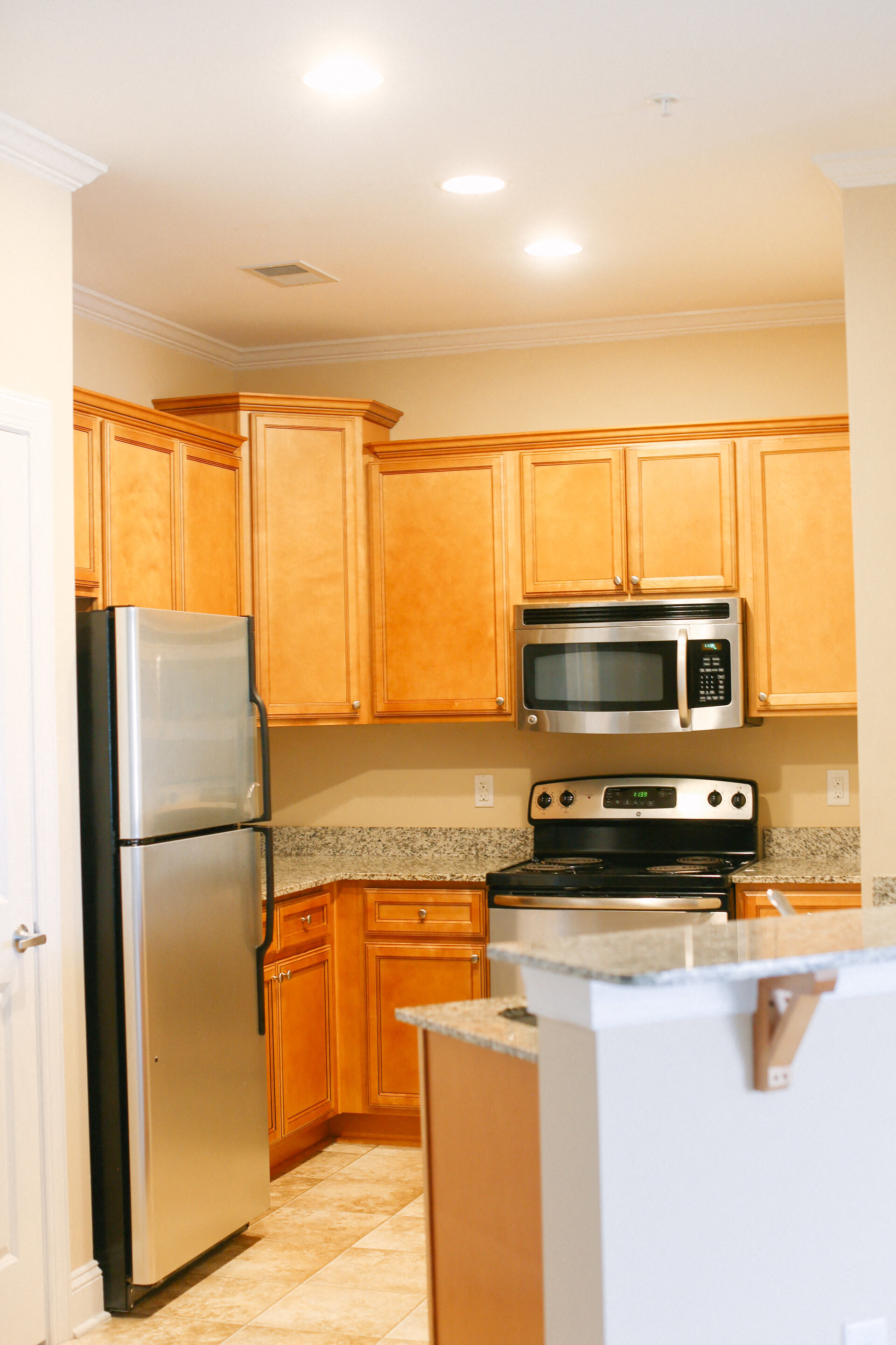 a kitchen with wooden cabinets and stainless steel appliances
