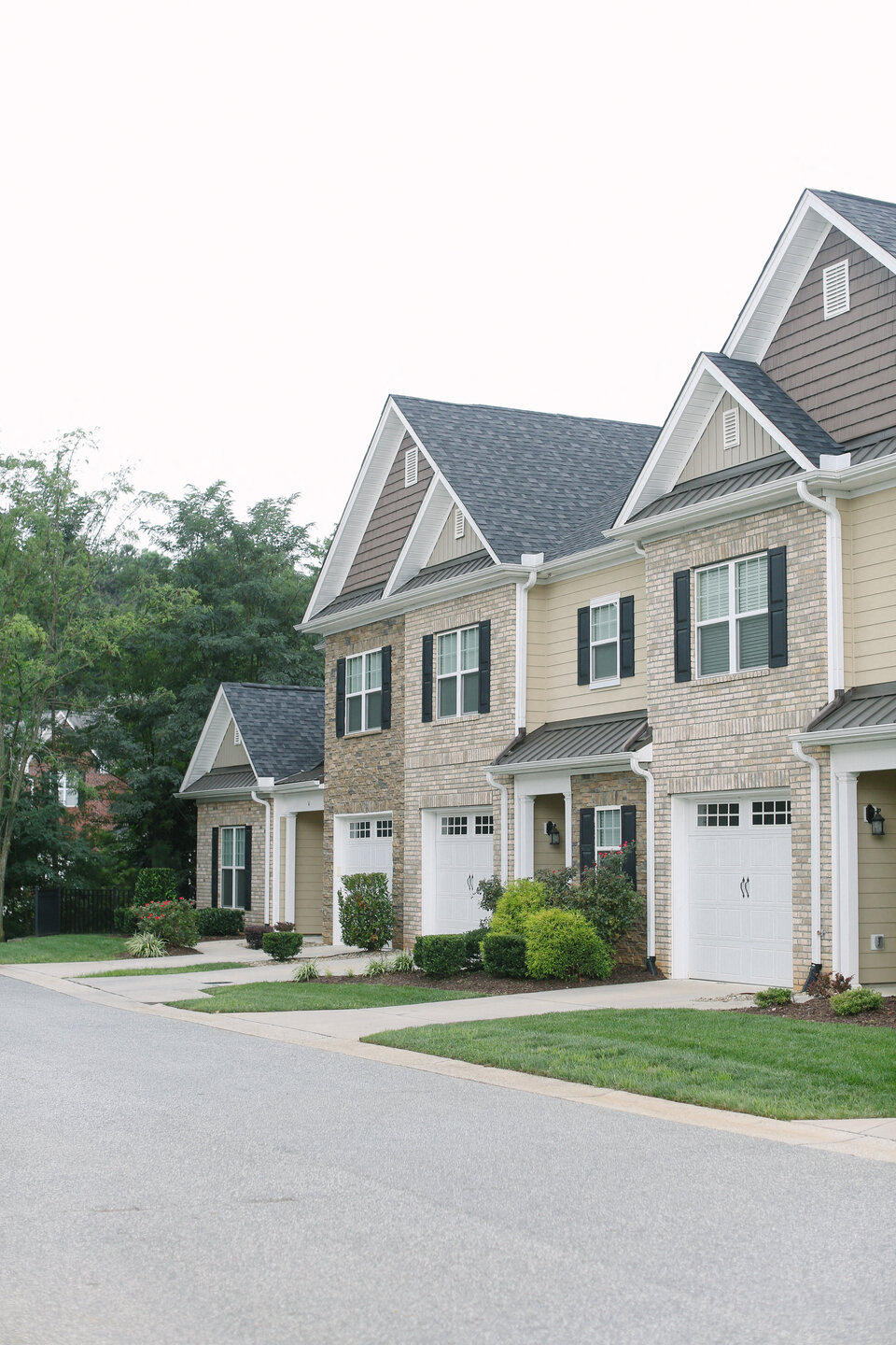 a row of houses with a street in front of them