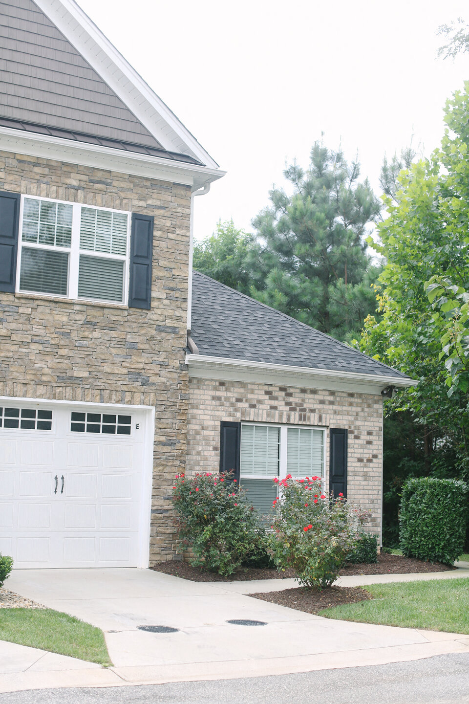 a white brick house with a white garage door