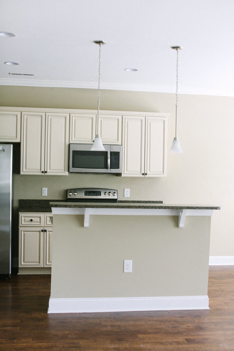 a kitchen with white cabinets and a counter top