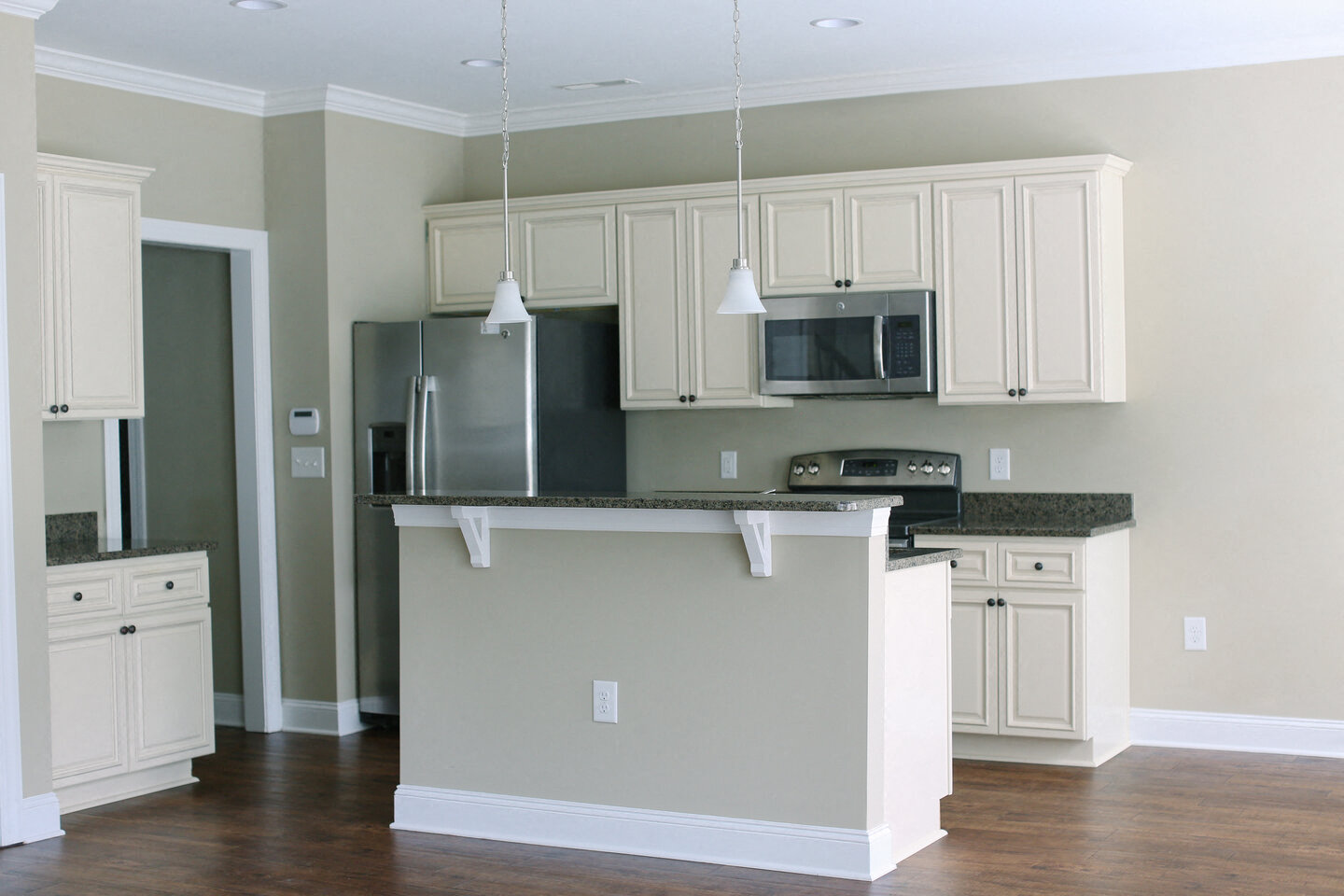 a kitchen with white cabinets and a counter top