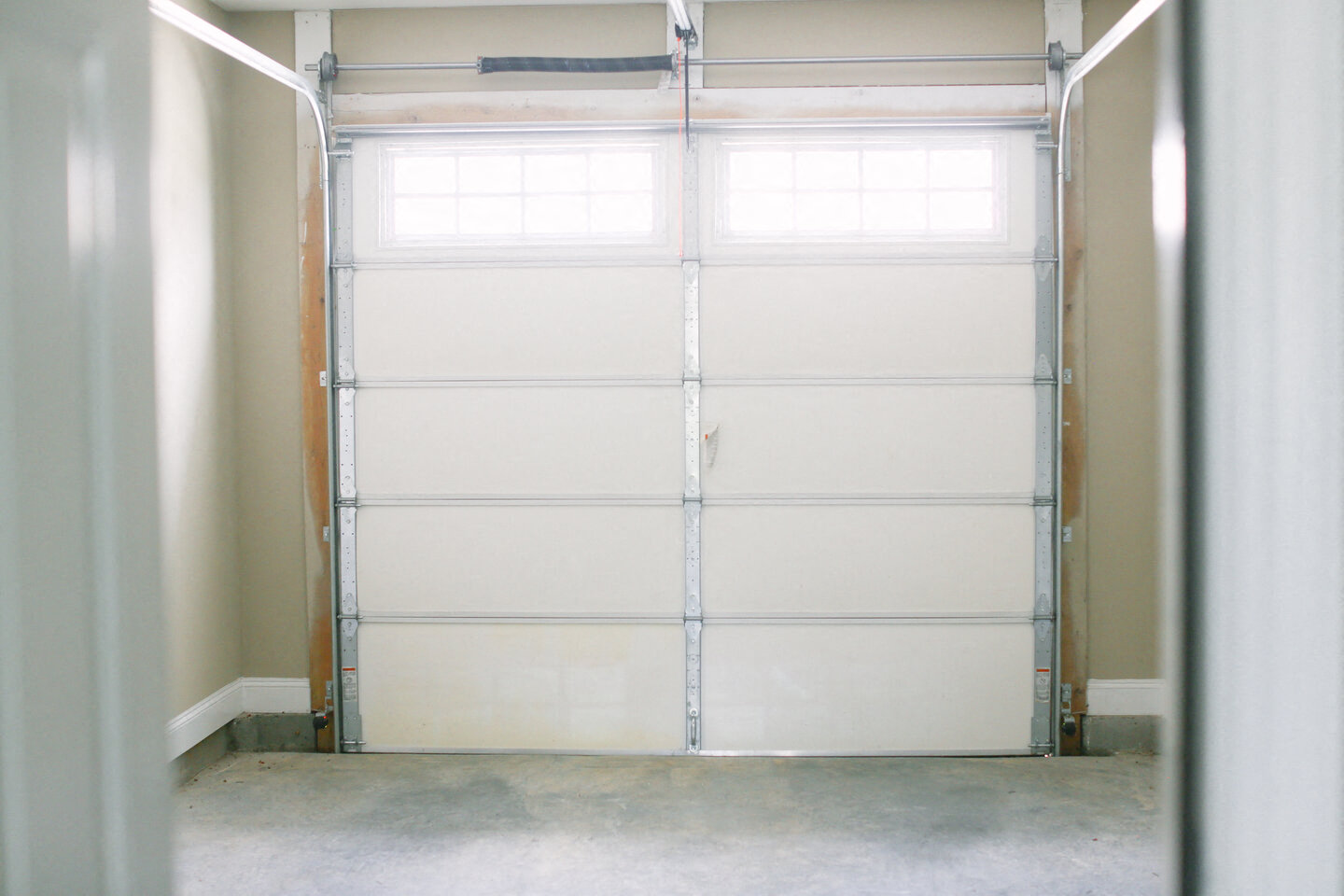a white garage door with a window in it