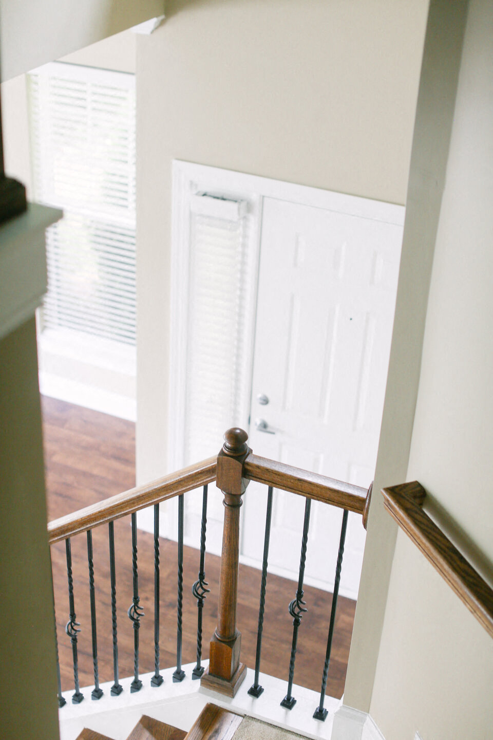 a view from the top of a staircase looking into a white door
