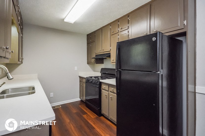 a kitchen with black appliances and white counter tops