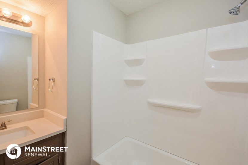 a bathroom with a sink and a toilet and a mirror