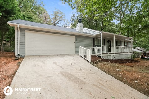 a white house with a driveway and a white garage door