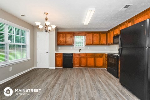 a kitchen with black appliances and wooden cabinets