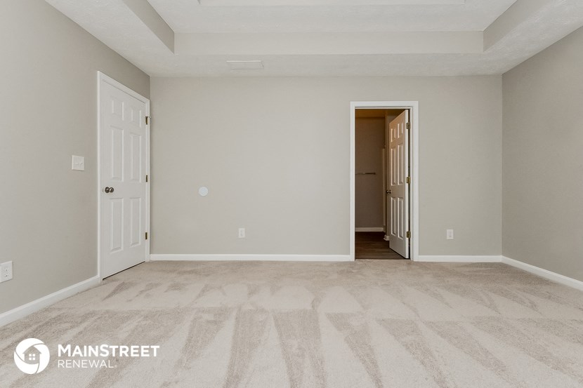 the spacious living room of an apartment at the residence