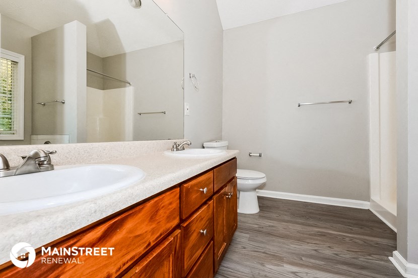 a bathroom with a sink and a toilet and a mirror