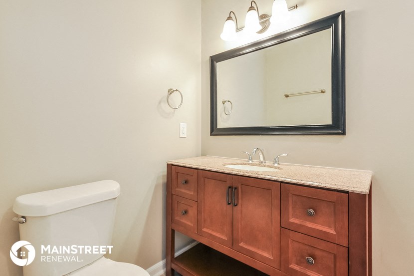 a bathroom with a sink and a mirror and a toilet