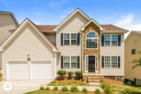 a beige house with a white garage door