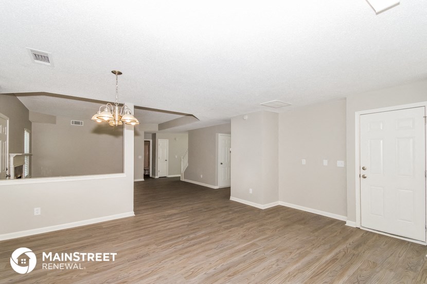 the living room and dining room of an apartment
