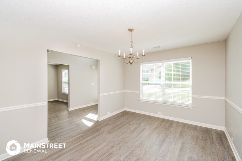the living room and dining room of a new home