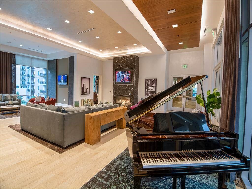 a living room with a piano and a couch