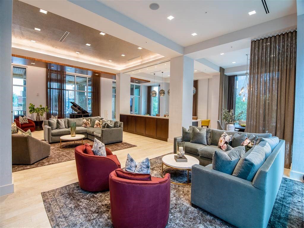 a large living room with couches and chairs