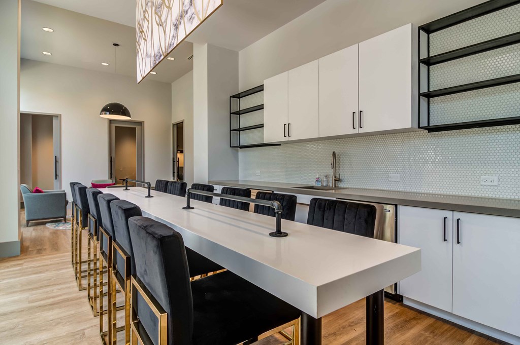 a long kitchen with a long table and chairs