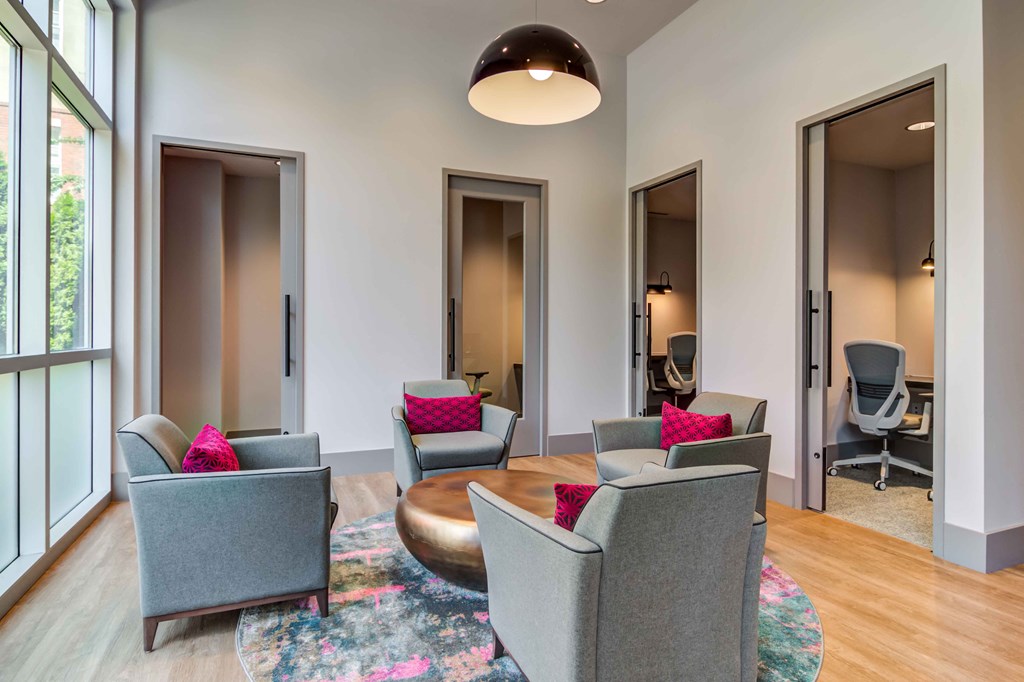 a living room with chairs and a coffee table