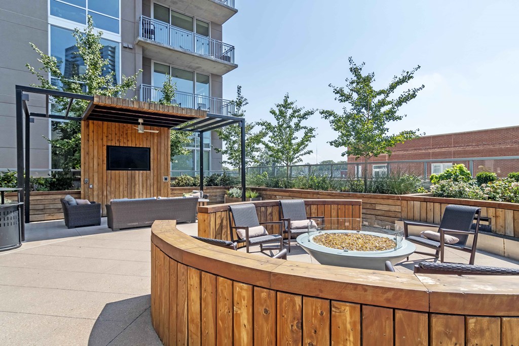 an outdoor patio with chairs and a fire pit