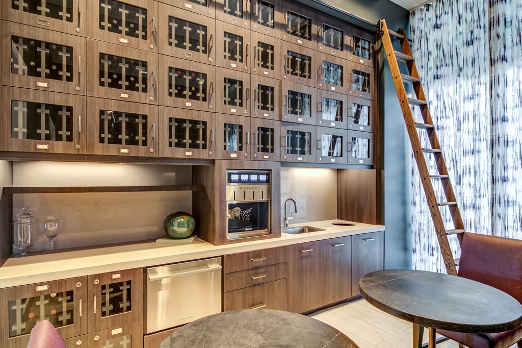 a kitchen with a wall of wine racks and a ladder