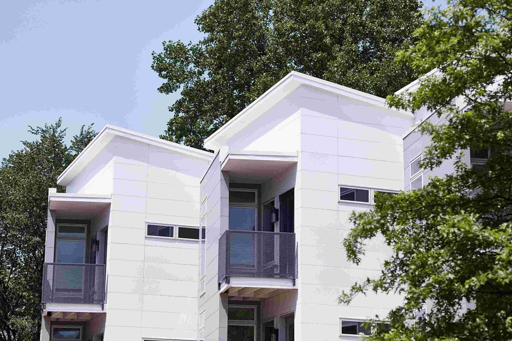 a white house with a tree in front of it