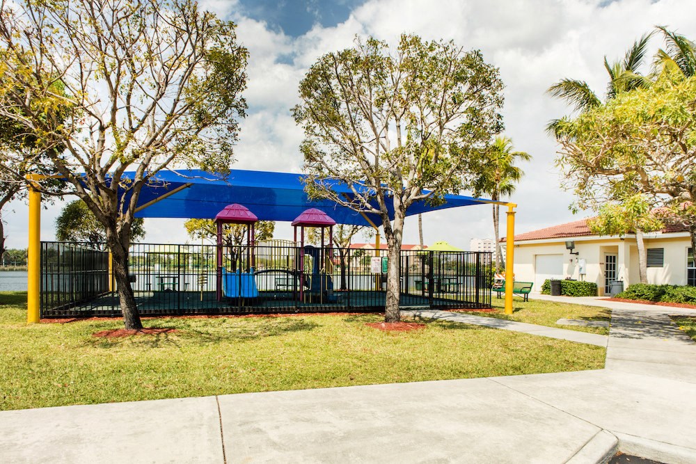 modern fenced playground area at Crystal Lake Apartments