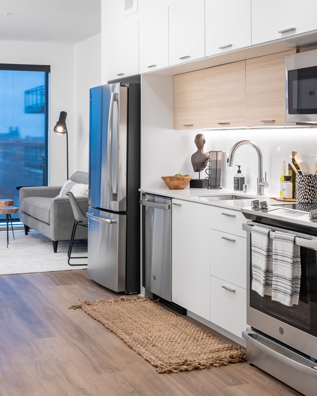 Studio kitchen with stainless steel appliances and white granite countertops at Platform