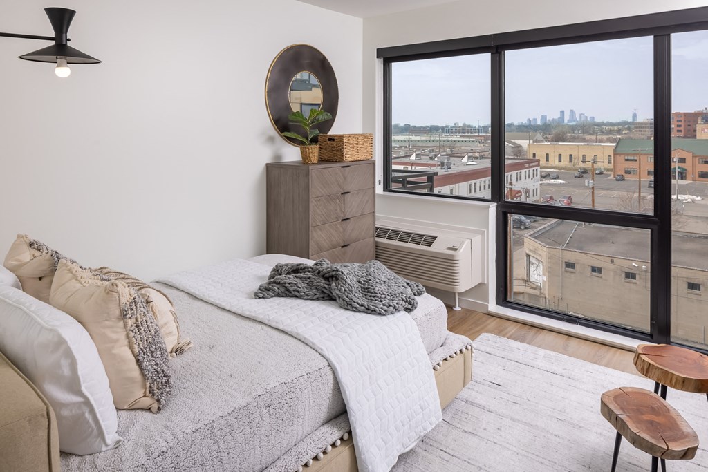 Studio sleeping area showing bed with west-facing window at Platform